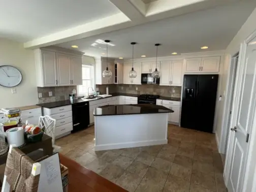 Modern kitchen with island and pendant lighting.